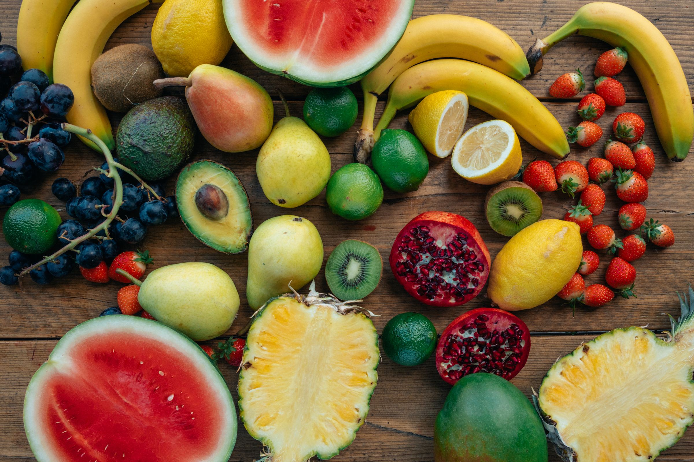 A colourful selection of fresh seasonal fruit on a wooden table
