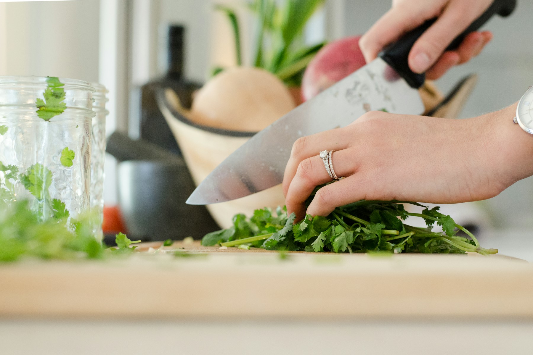 Fresh coriander being prepared in a kitchen